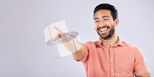 Image of Happy, laughing and Asian man pointing for bullying isolated on a grey studio background. Funny, joke and Japanese with a hand gesture for making fun, prank and amusement on a backdrop with mockup