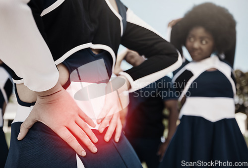 Image of Cheerleader, sports or woman with back pain, injury or accident on field in game or training match. Red glow, fitness or cheerleading girl athlete with medical emergency, body joint or muscle sprain