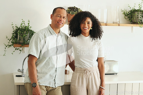 Image of Happy, love and portrait of a couple in the kitchen of their new modern home together in Mexico. Happiness, smile and mature married man and woman bonding and embracing while standing in their house.