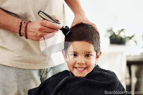 Image of Portrait, kid and shaving hair at barber for grooming, cleaning and trim. Smile, face and happy boy or child getting a haircut with electric shaver of hairdresser at salon for new look and hairstyle.