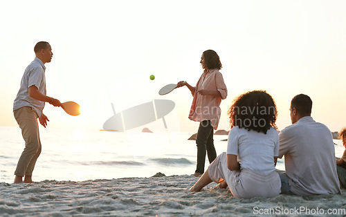 Image of Beach, ping pong and family on a summer vacation, adventure or weekend trip in Australia. Travel, fun and people playing a sports game on the sand by the ocean while on a seaside holiday together.