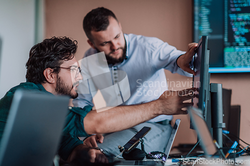 Image of Programmers engrossed in deep collaboration, diligently working together to solve complex problems and develop innovative mobile applications with seamless functionality.