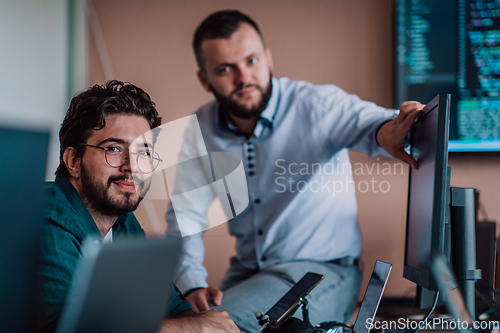 Image of Programmers engrossed in deep collaboration, diligently working together to solve complex problems and develop innovative mobile applications with seamless functionality.