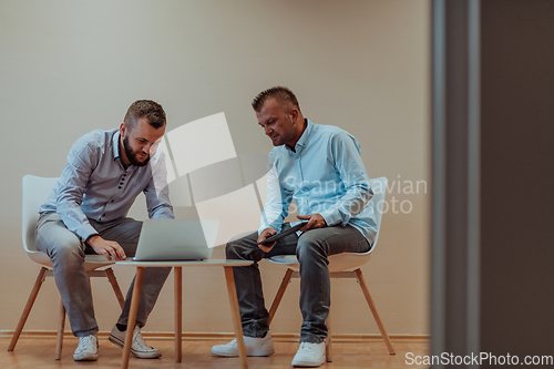 Image of Programmers engrossed in deep collaboration, diligently working together to solve complex problems and develop innovative mobile applications with seamless functionality.