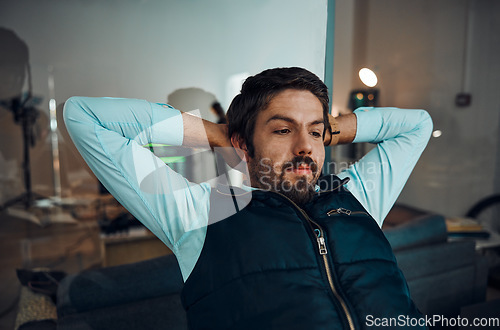 Image of Relax, break and man in an office for work, success and working at night for a deadline. Looking, corporate and businessman with stress relief, relaxed and overtime in the workplace in the dark