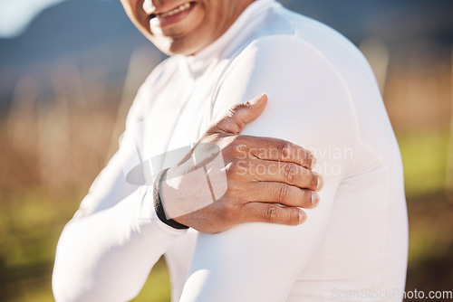 Image of Hand, shoulder and injury with a runner man outdoor for cardio or endurance exercise in nature. Pain, arm and emergency with a male athlete suffering from cramp after an accident while running