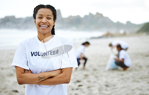 Image of Portrait, smile and volunteer woman at beach for cleaning, recycling and sustainability. Earth day, laughing and proud female with arms crossed for community service, charity and climate change.