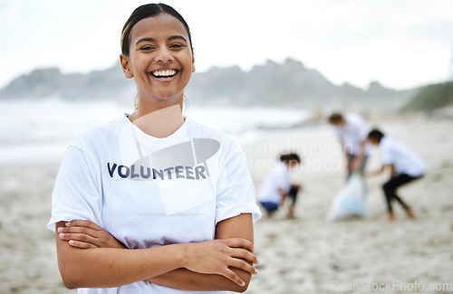 Image of Smile, portrait and volunteer woman at beach for cleaning, recycling and sustainability. Earth day, laughing and proud female with arms crossed for community service, charity and climate change.