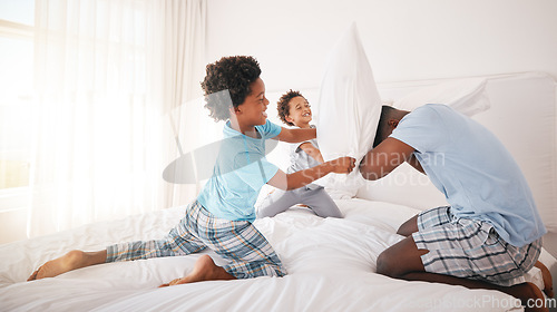 Image of Black family, pillow fight and bedroom bonding of a father, children and fun in a home. Papa, kids and crazy play fighting of youth with energy in the morning in a house with dad feeling love