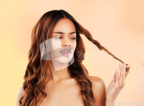 Image of Hair, salon and black woman with damage isolated on studio background, frustrated face with split ends and dryness. Haircare, treatment and unhappy African model with stressed dry curly hairstyle.