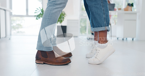 Image of Closeup, shoes and couple in tiptoe moment, romance and sweet relationship in their home. Feet, love and man with woman embracing, leaning and sharing intimate, embrace and romantic in living room