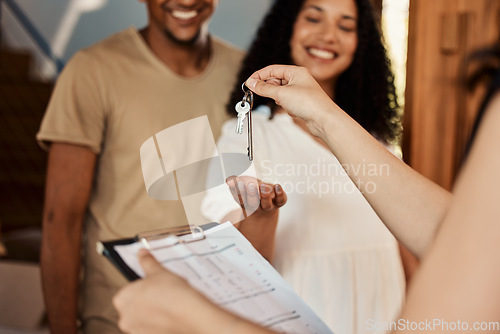 Image of Realtor keys, couple home purchase and real estate contract of a happy woman and man. House, happiness and property sale of residential homeowner people ready for moving with mortgage paperwork