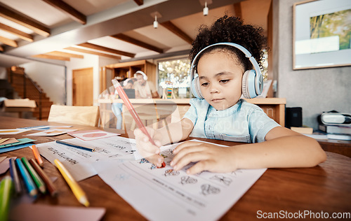 Image of Art, headphones and child drawing a picture while listening to music, audio book or radio. Creative, artistic and young girl kid writing on paper for homework while streaming song, album or playlist.