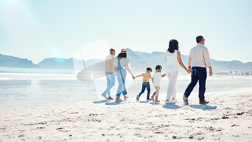 Image of Beach, love and big family holding hands while walking on a vacation, adventure or weekend trip. Travel, seaside and children on walk with their parents and grandparents by the ocean while on holiday