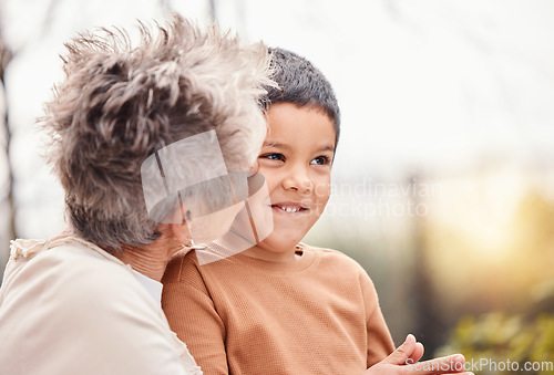 Image of Children, family and love with a grandmother kissing her grandson outdoor in the garden of their home. Kids, kiss or cute and a senior woman bonding with her male grandchild together in summer