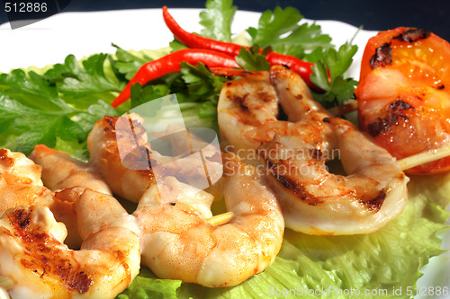 Image of Grilled prawns on bamboo sticks served on lettice