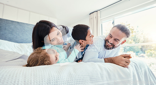 Image of Happy, love and family being playful on the bed together in the bedroom of their modern house. Happiness, excited and children having fun, playing and bonding with their parents in a room at home.