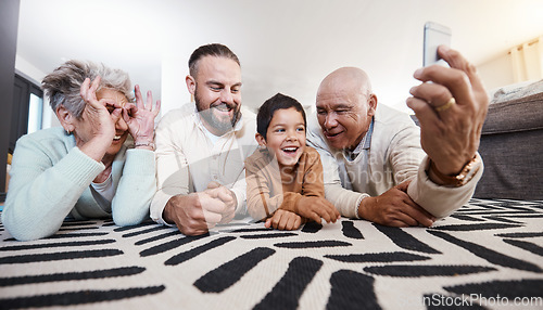 Image of Happy big family, smile and take selfie in home living room for memory or social media. Photographer care, comic face and father, grandparents and child on floor taking pictures, bonding or laughing.