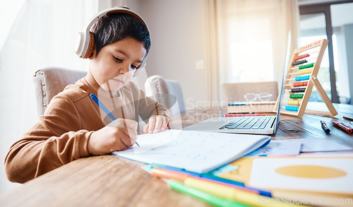 Image of Learning headphones, math education and kid in home with book for studying, homework or homeschool. Development, laptop or boy or child with notebook for numbers in elearning, virtual or online class