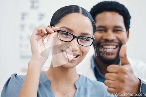 Image of Portrait, thumbs up or customer glasses in eyes healthcare, optometry wellness or vote at retail store, shop or clinic. Smile, happy or woman with thumb, optician help or winner prescription vision