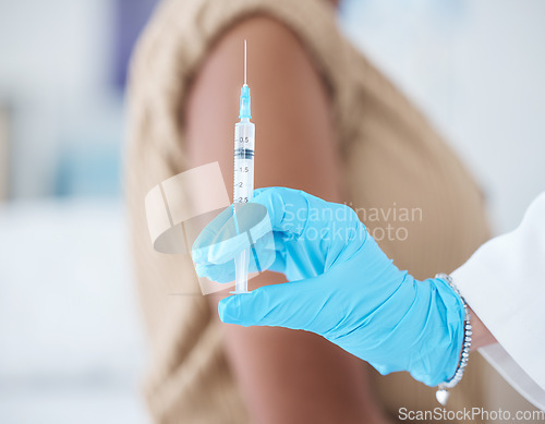 Image of Doctor hands, injection and vaccine for woman in healthcare clinic, hospital and wellness services. Needle, medical nurse and covid medicine for patient safety, virus risk and safety of sick immunity