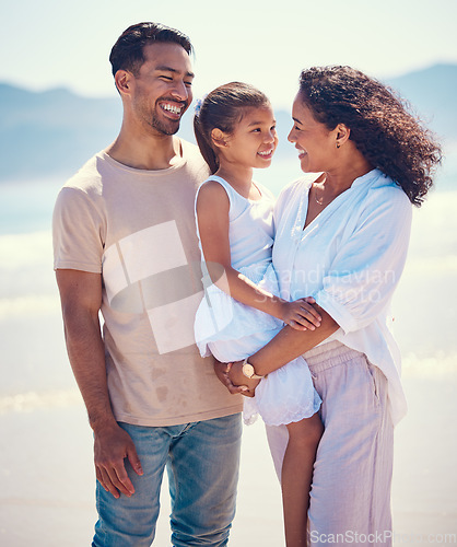 Image of Happy family, beach and hug of a mother, father and girl together by the ocean. Nature, sea and love of a mom, dad and child from the Philippines on a vacation with parents on travel holiday