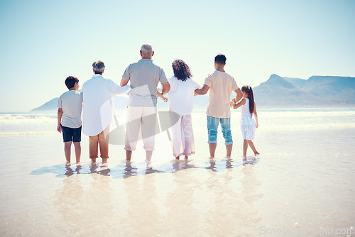 Image of Black family, beach or holding hands with children, parents and grandparents standing in the water from behind. Back, nature or view with kids, senior people and relatives bonding in the ocean