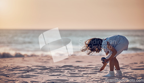 Image of Mockup, girl and beach for summer vacation, sand and search for seashells, happiness and water. Female child, kid and young person on seaside holiday, collection or freedom with peace, relax or break