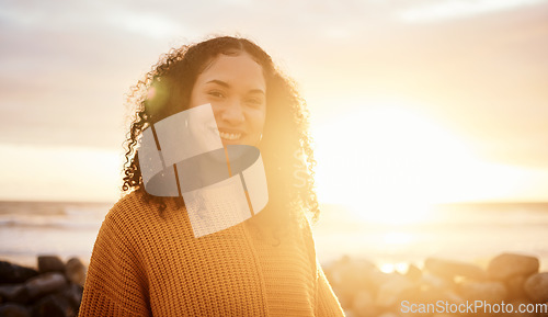 Image of Travel, sunset and portrait of a woman at the beach while on a zen vacation or weekend trip. Happy, smile and calm female from Puerto Rico by the ocean while on a seaside holiday or adventure.