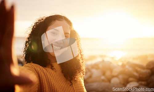 Image of Selfie, sunset and mockup with a black woman on the beach during summer for a holiday or vacation. Portrait, sunrise and flare with an attractive young female posing for a photograph on the coast