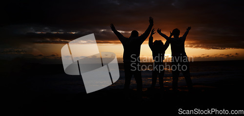 Image of Freedom, sunset and silhouette of a family at the beach while on a summer vacation or weekend trip. Adventure, carefree and shadow of people by the ocean together while on a seaside travel holiday.