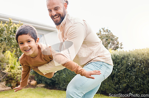 Image of Carefree, flying and portrait of a father with a child in a garden for freedom, play and bonding. Happy, laughing and dad holding a boy kid to fly while playing in the backyard of a house together