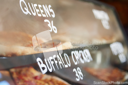 Image of Shop display, pizza and fast food price, service and take away restaurant with closeup, storefront and window. Dinner, nutrition at cafe or bakery, lunch or dinner with to go meal option in New York