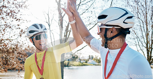 Image of Cycling men or friends high five for sports winning, marathon travel award and countryside competition or race success. Winner athlete or people in teamwork, triathlon journey goals and support hands