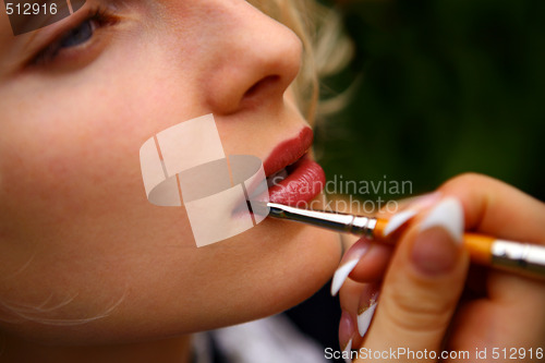 Image of beautiful  woman put in on make-up