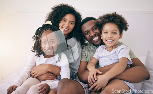 Image of Black family, happiness and portrait of a mother, father and girl children on a bed with a smile. Bedroom, home and happy kids with parent love and support from mama and dad together in the morning