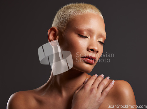 Image of Woman, beauty and skincare makeup for cosmetic treatment against a gray studio background. Beautiful female model touching skin in cosmetics for self love or body care wellness in satisfaction