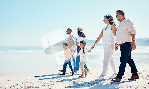 Image of Beach, walking and mock up with a black family holding hands outdoor in nature by the ocean at sunset together. Nature, love or kids with grandparents, parents and children taking a walk on the coast