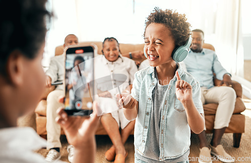 Image of Filming, phone and music with big family in living room for social media, live streaming and dance. Network, internet and technology with boy and video recording at home for singing, funny and comedy