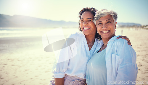 Image of Mother with her adult daughter at the beach while on a vacation, weekend trip or summer getaway. Happy, smile and woman embracing her senior mom by the ocean while on a tropical holiday or adventure.