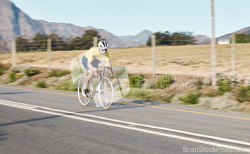 Image of Cycling, fitness and man with bicycle on road, challenge and action with workout, cyclist outdoor and helmet for safety. Riding, athlete and training for race or triathlon, exercise with bike