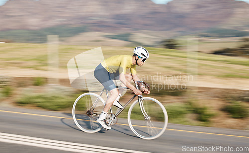 Image of Cycling, fitness and man with bicycle on road, speed and action, motion blur of cyclist outdoor and helmet for safety. Mockup space, athlete and training for race, exercise in countryside with bike