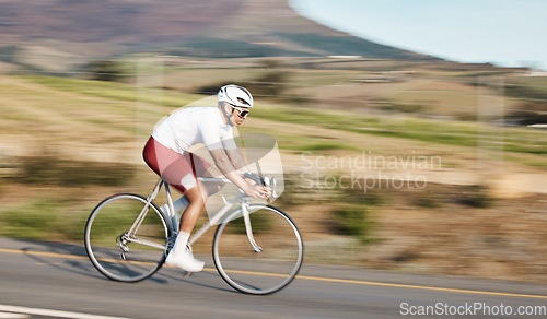 Image of Cycling, exercise and man with bike on road, speed and action with motion blur of cyclist outdoor and helmet for safety. Mockup space, athlete and training for race, fitness in nature with bicycle