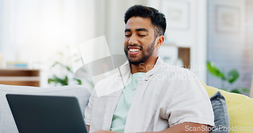 Image of Laptop, laughing and man on couch watching funny video, live streaming or reading post on social media. Happy person relaxing on sofa with computer, internet and wifi in his apartment or living room