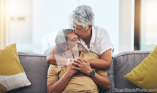 Image of Love, kiss and senior couple on sofa for bonding, healthy marriage and relationship in living room. Retirement, hug and loving man and woman on couch embrace for trust, commitment and care at home