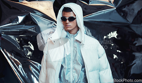 Image of Holographic, sci fi and man with fashion and futuristic ski style with vaporwave clothing in studio. Art, creative and young male model with trendy, cool sunglasses and cyberpunk designer jacket