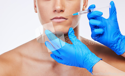 Image of Man, syringe and lip filler surgery in studio with doctor for beauty, wellness or facial change by white background. Young model, needle and hands for mouth, cosmetic transformation and dermatology