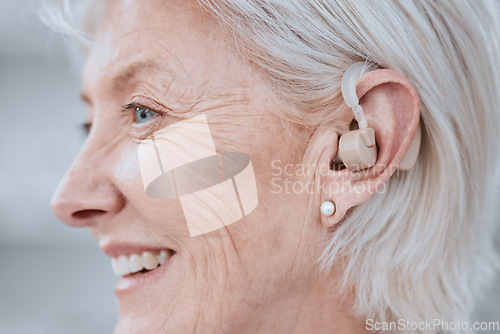 Image of Senior woman, hearing aid and ear with smile, profile and audio for listening for healthcare in retirement. Elderly lady, deaf or person with disability with technology, sound or implant for wellness