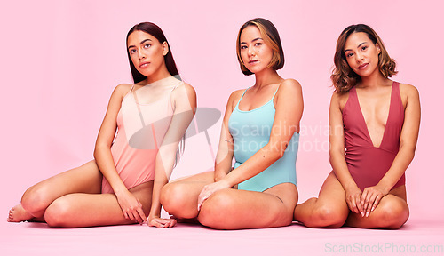 Image of Swimsuit, studio and portrait of women together with bikini, underwear and body positivity. Diversity, summer fashion and swimwear models sitting with self love, equality and glow on pink background.