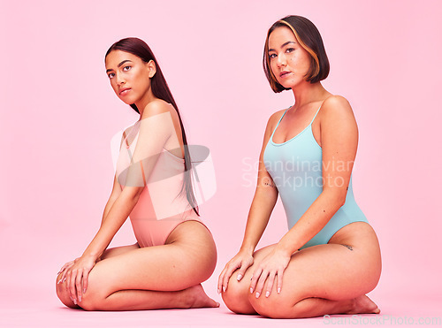 Image of Diversity, swimwear and portrait of women in studio, sitting together with glow and body positivity swimwear. Beauty, summer fashion and bikini models with self love, equality and pink background.